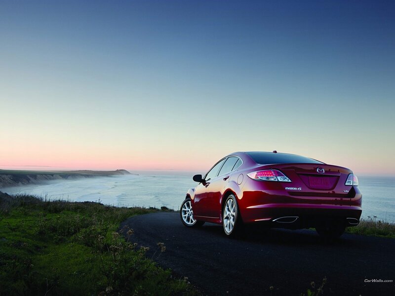 Red Mazda6 on coastal road