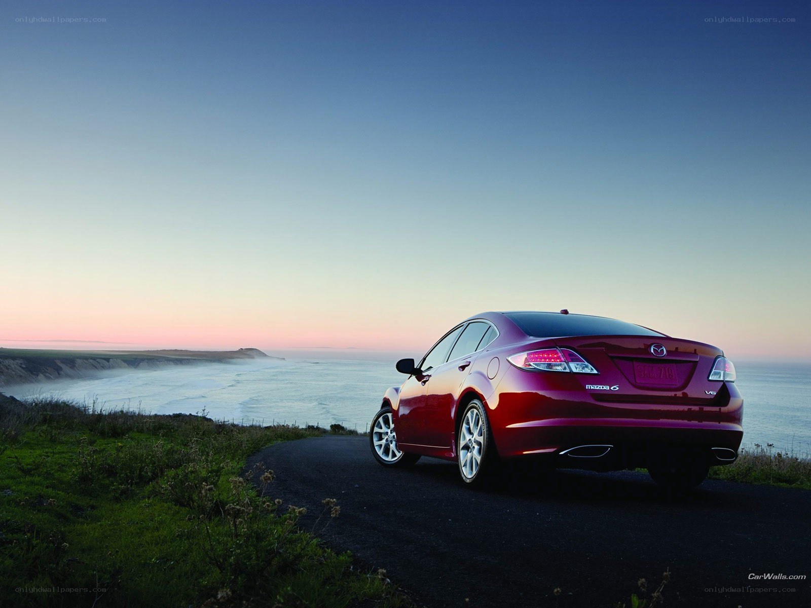 Red Mazda6 on coastal road