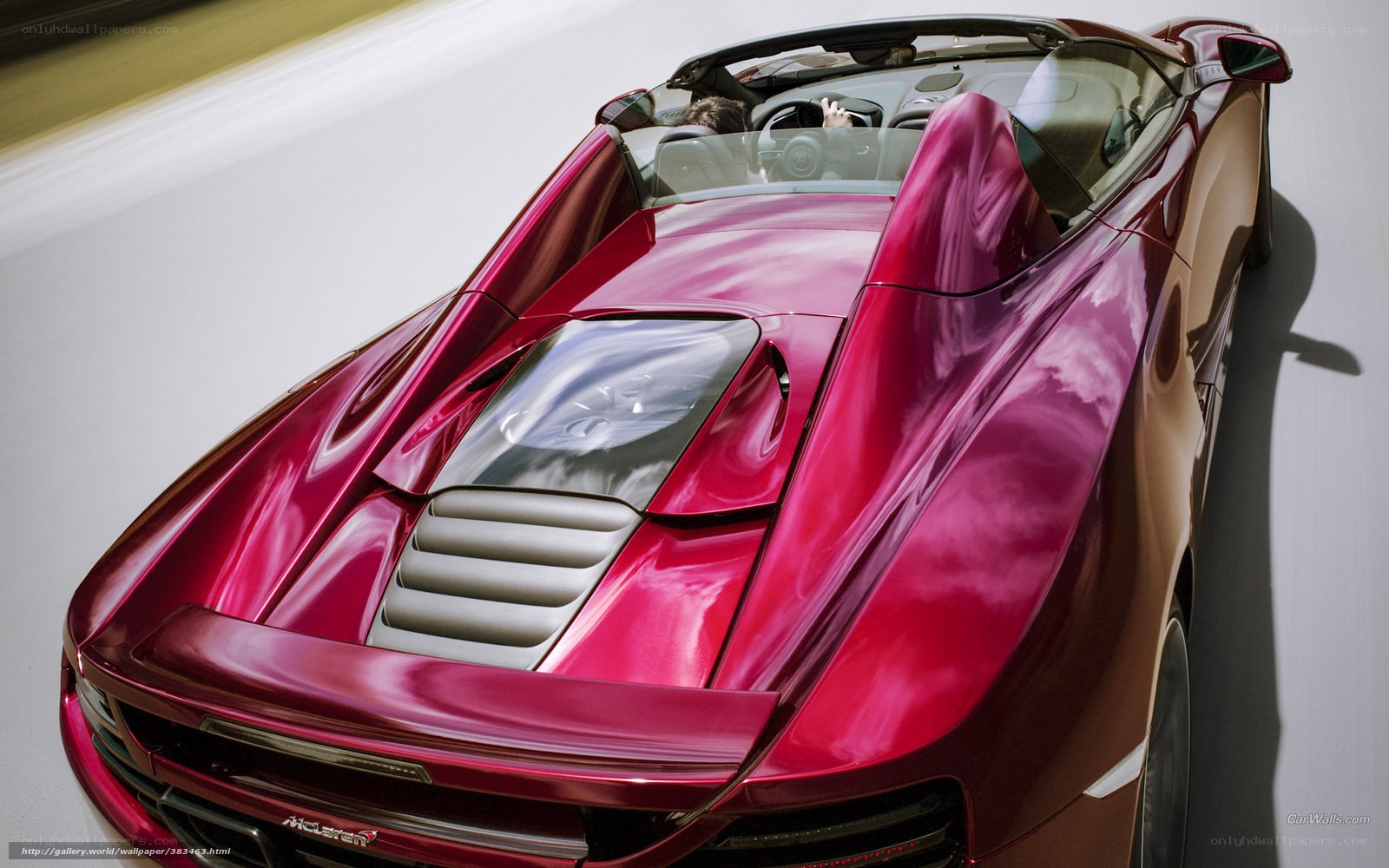 Red McLaren convertible in motion