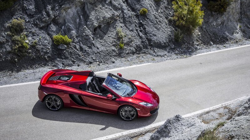 Red McLaren convertible on mountain road