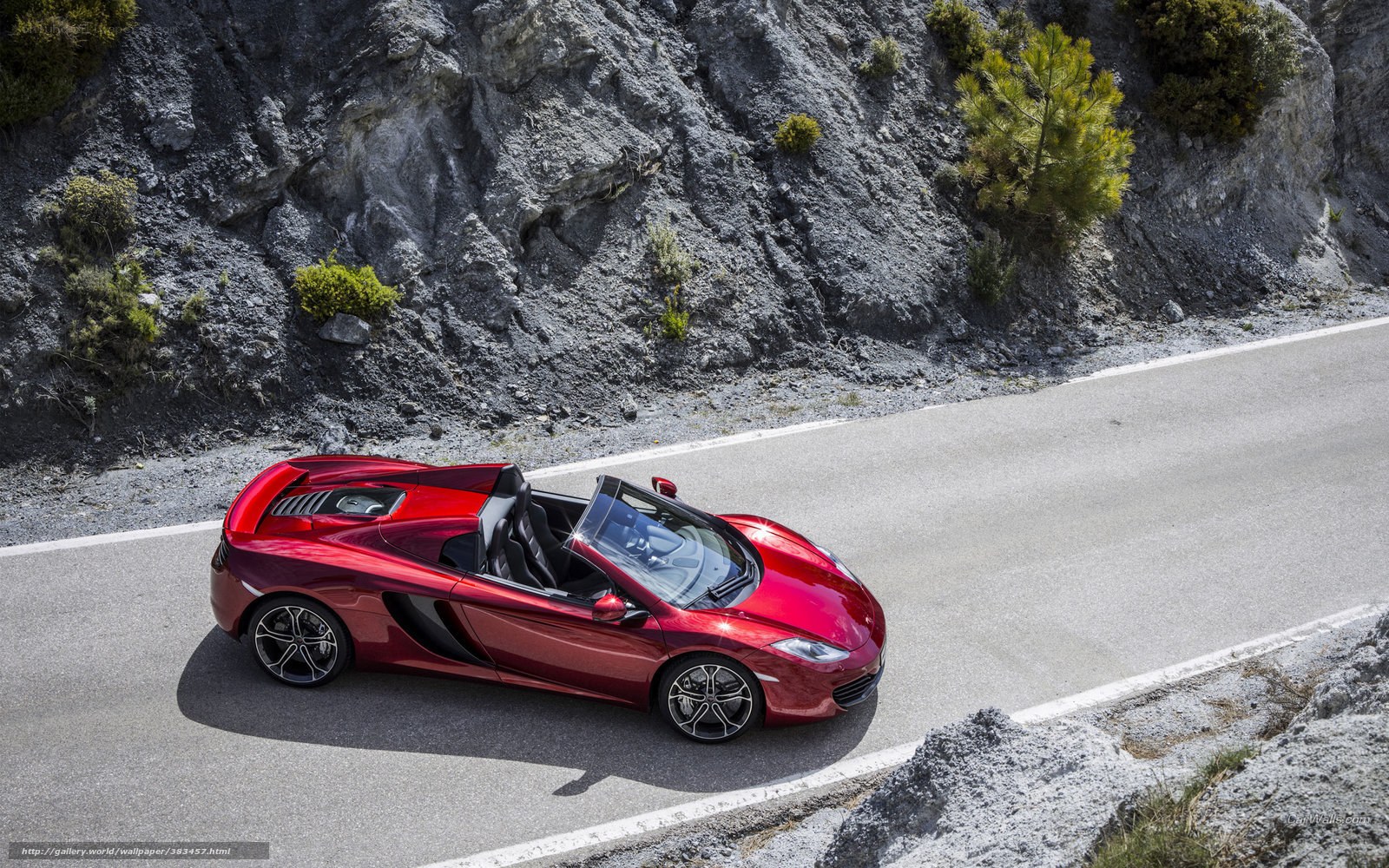 Red McLaren convertible on mountain road