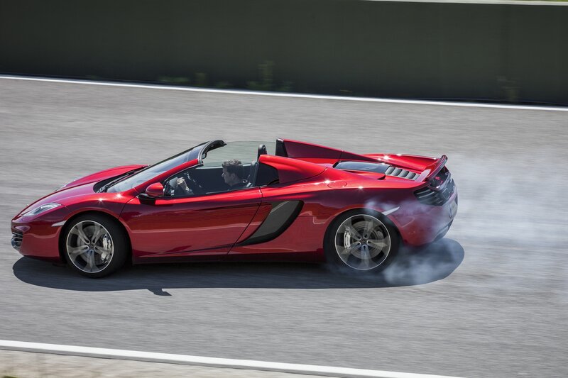 Red McLaren convertible on track