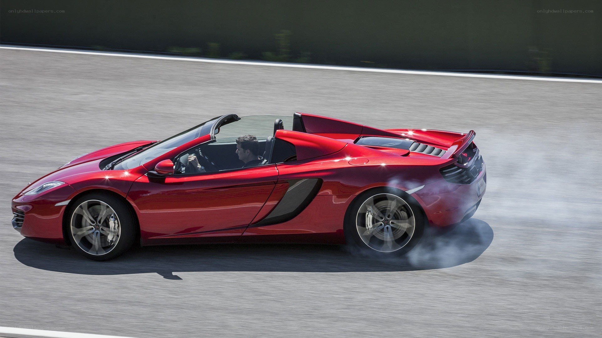 Red McLaren convertible on track