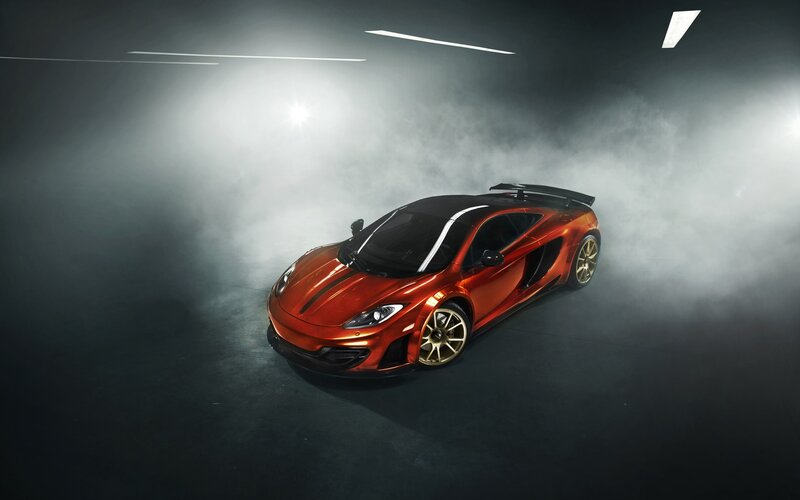 Red McLaren in a smoky studio