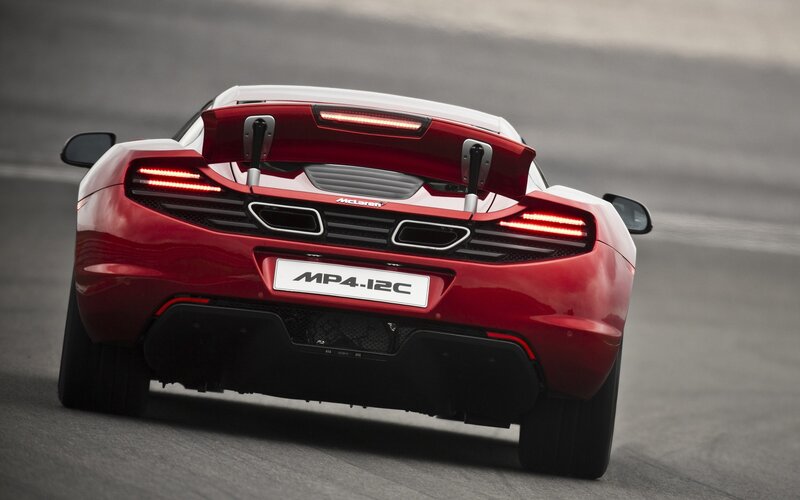 Red McLaren MP4-12C on track