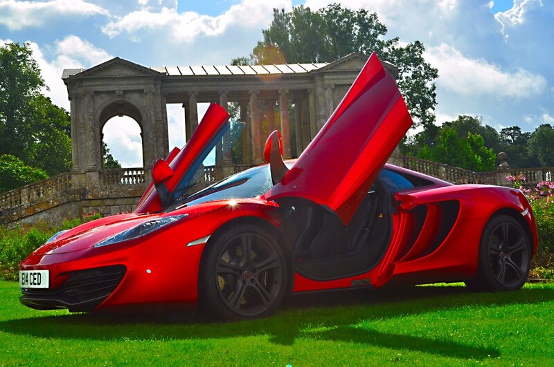 Red McLaren on a green lawn