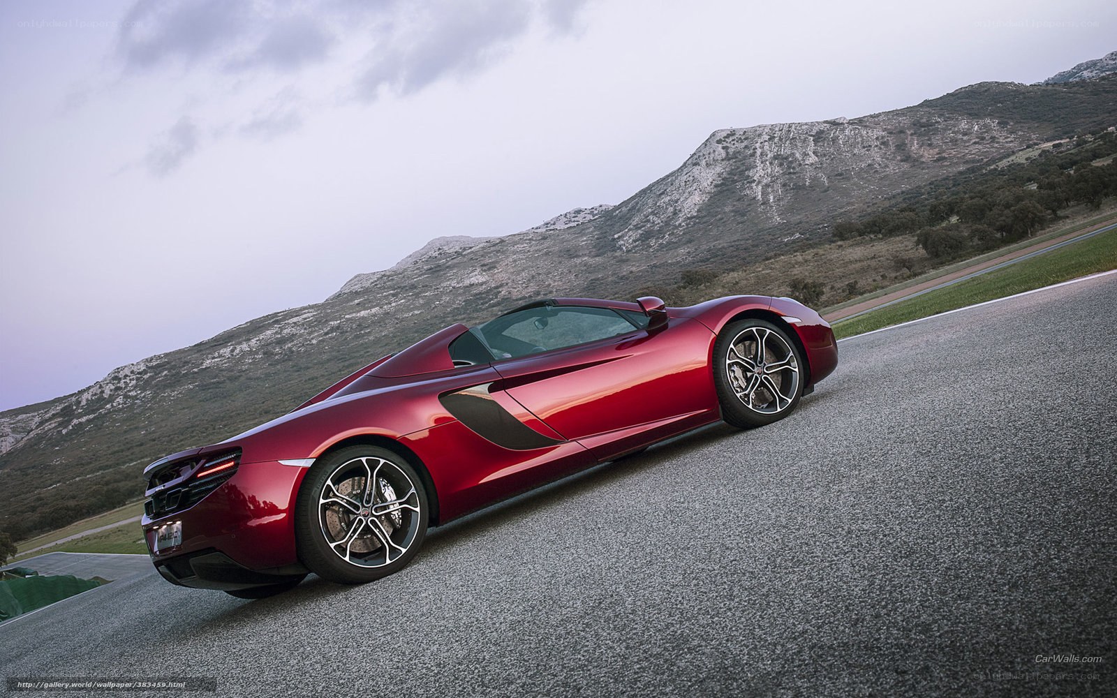 Red McLaren on a mountain road