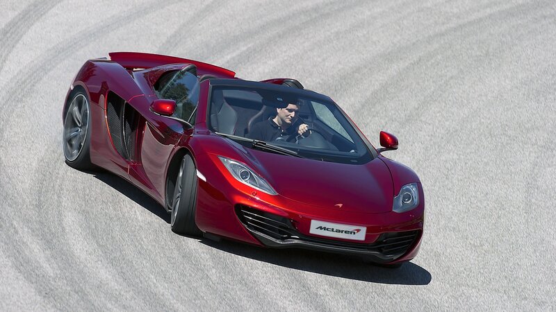 Red McLaren on a racetrack