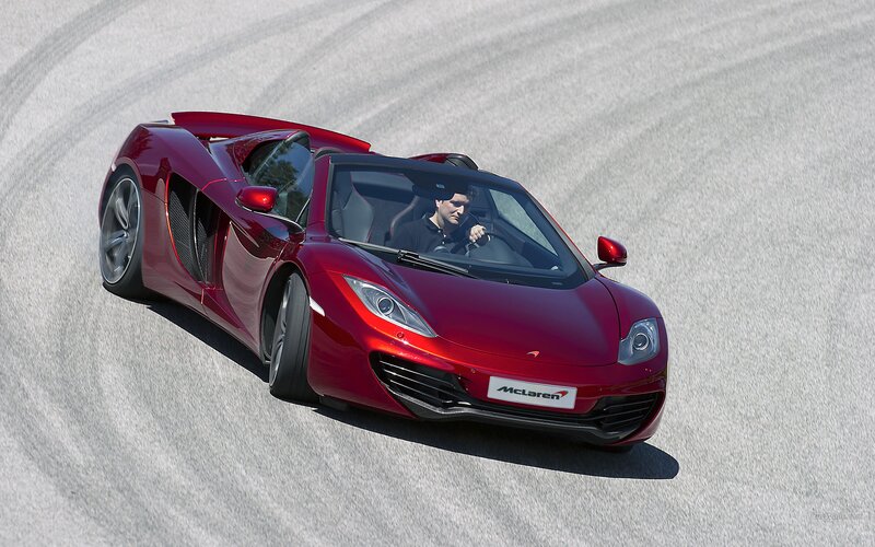 Red McLaren on a racetrack