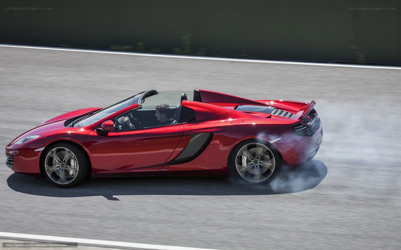 Red McLaren on a racetrack
