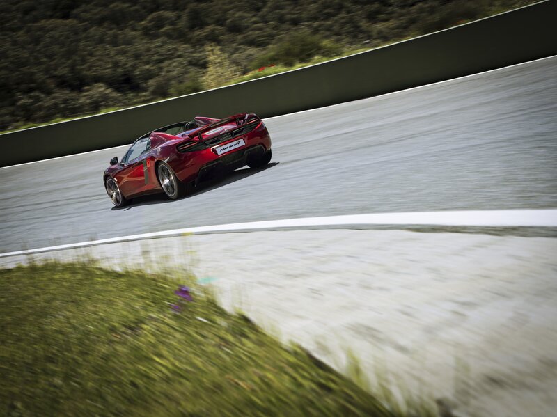 Red McLaren on a racetrack