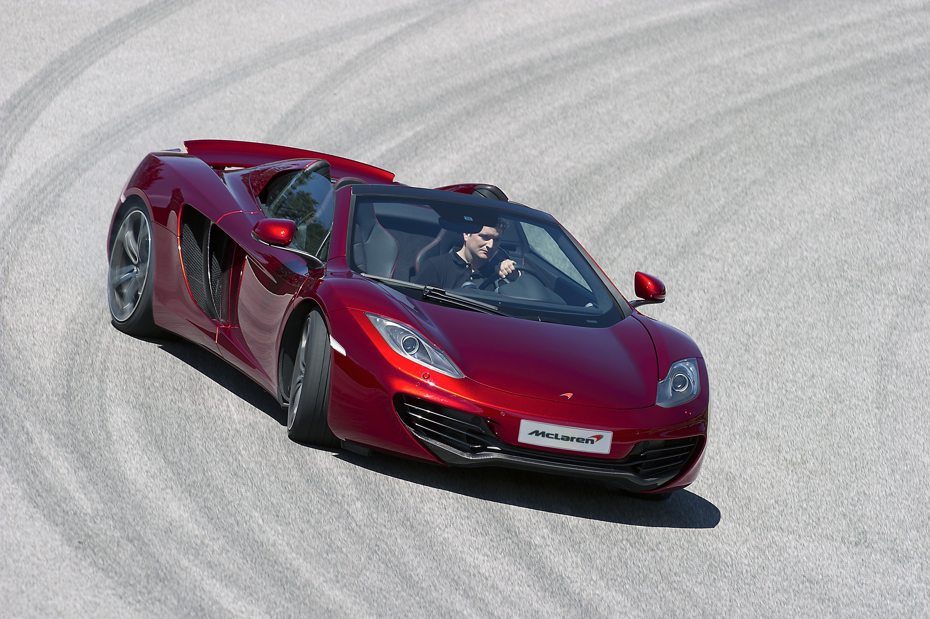 Red McLaren on a racetrack