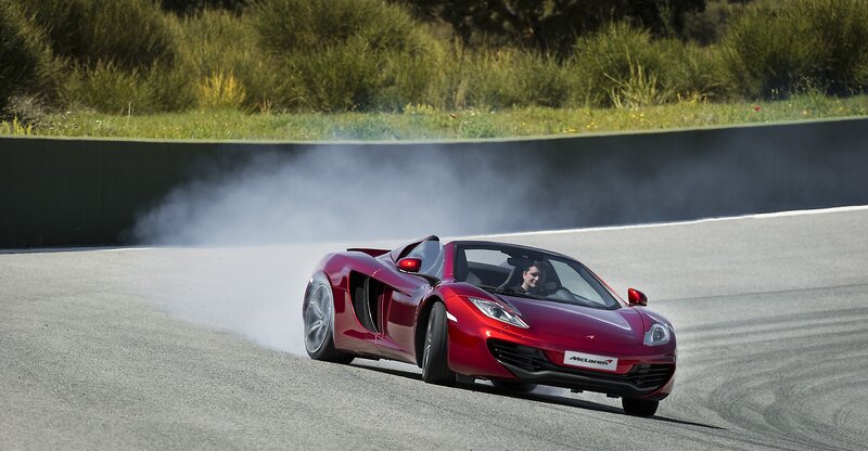 Red McLaren on a racetrack