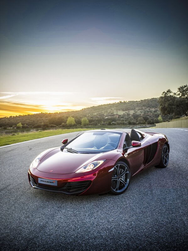 Red McLaren on a winding road