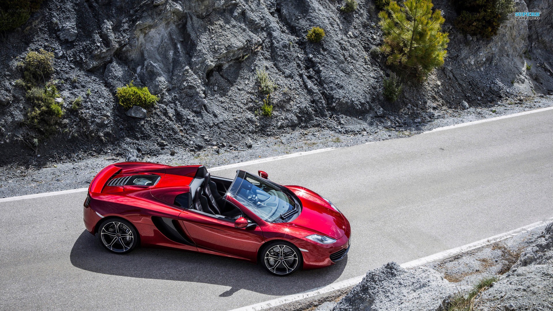 Red McLaren on mountain road