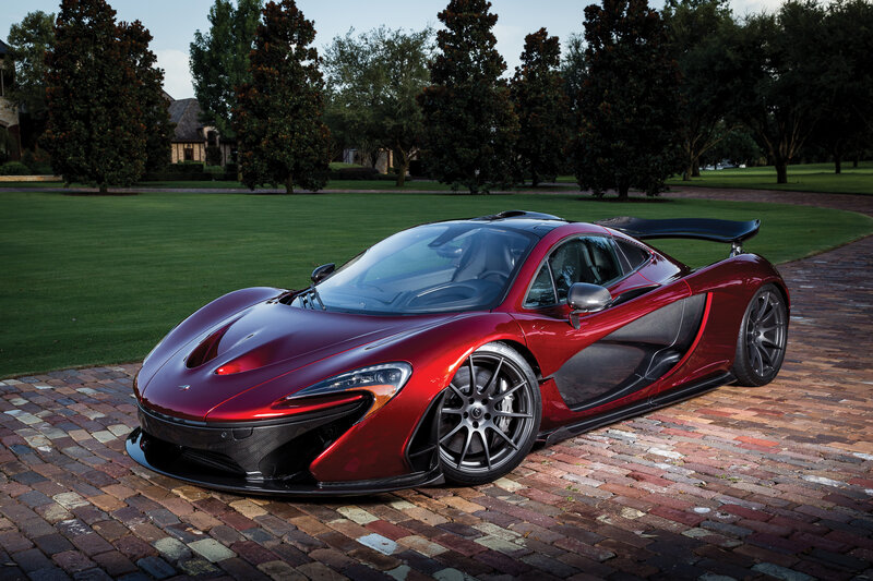 Red McLaren P1 on a brick driveway
