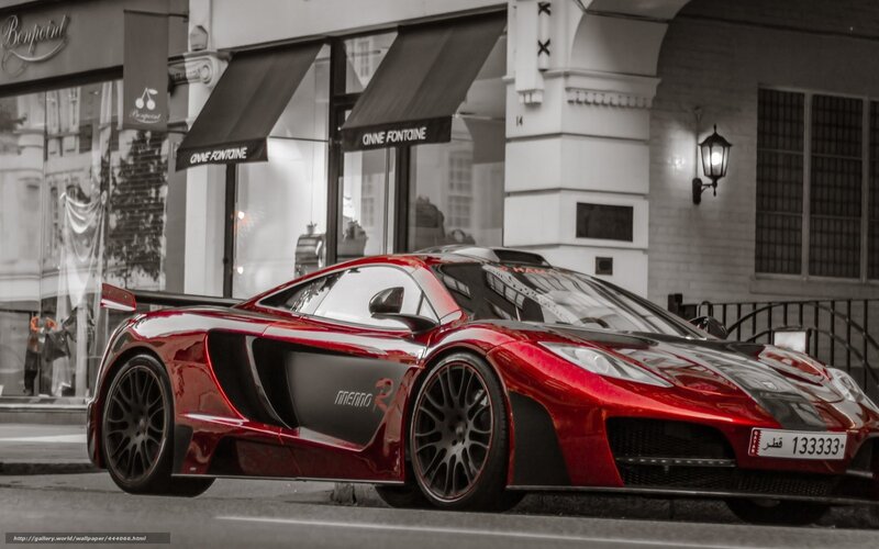 Red McLaren sports car on city street