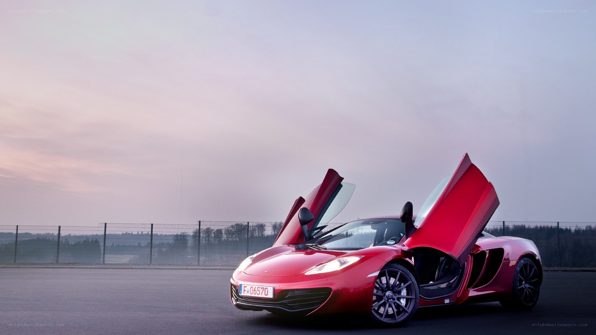 Red McLaren with doors open