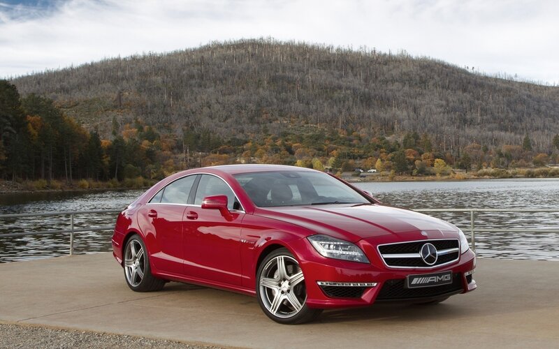 Red Mercedes-AMG CLS parked by lake
