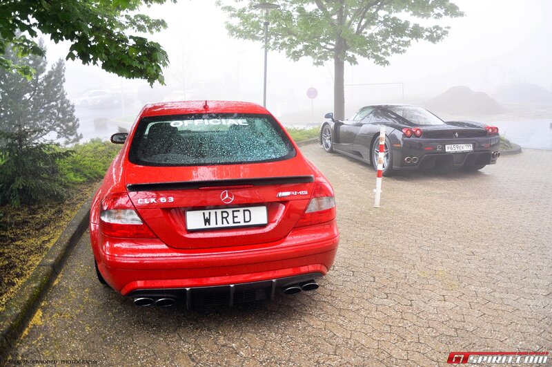 Red Mercedes and black Ferrari in fog
