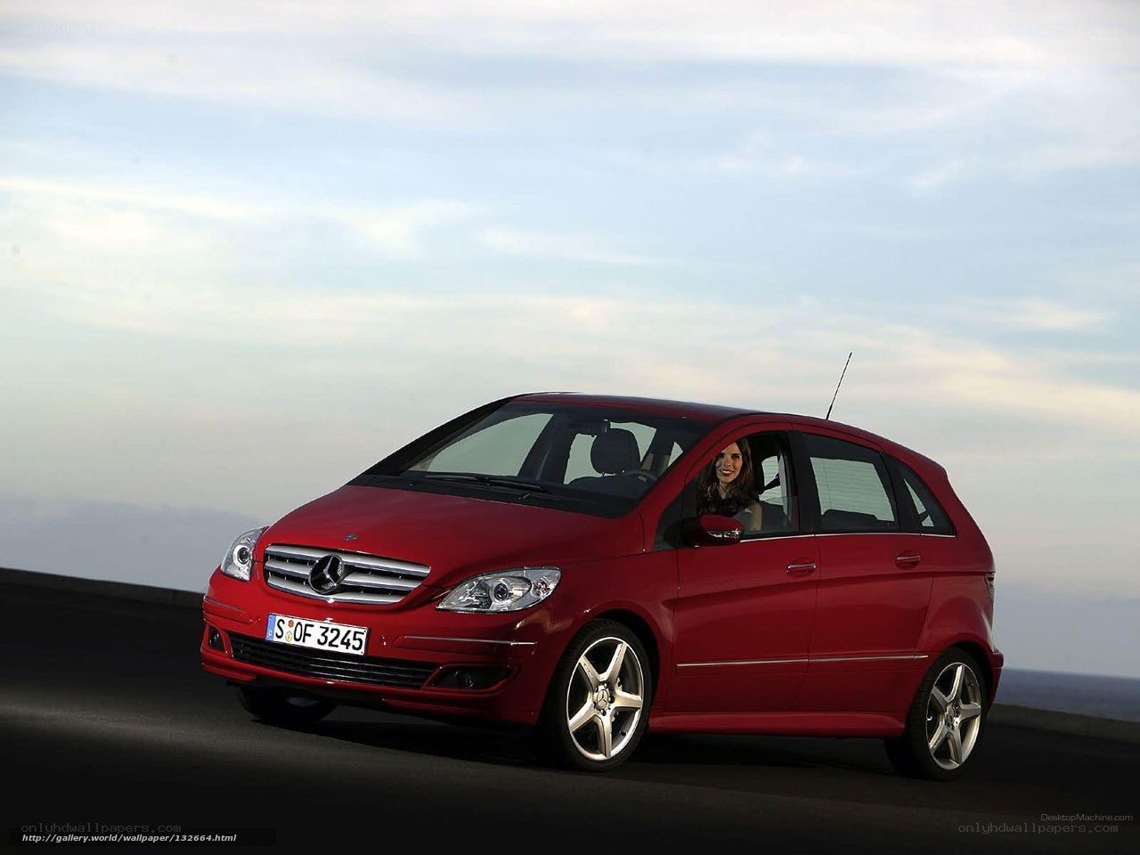 Red Mercedes-Benz B-Class on a coastal road