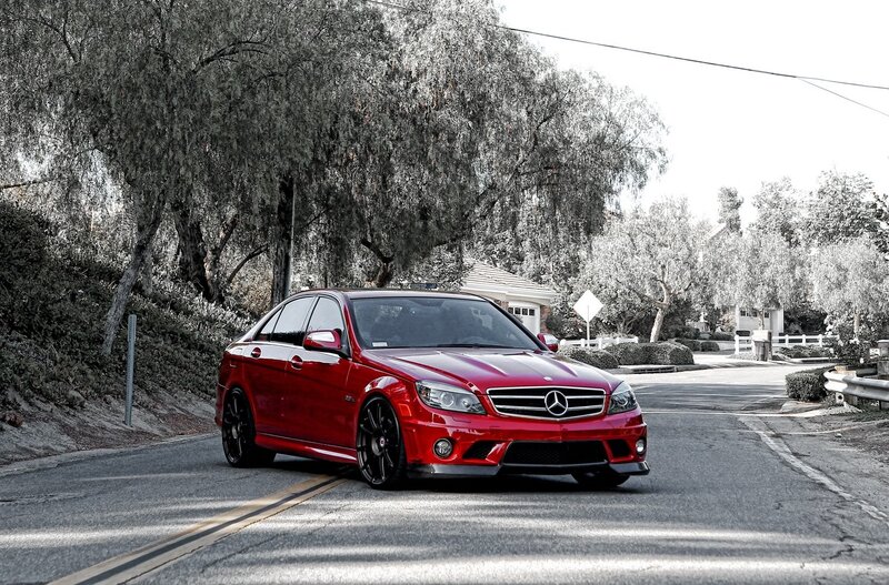 Red Mercedes-Benz C63 AMG on a road