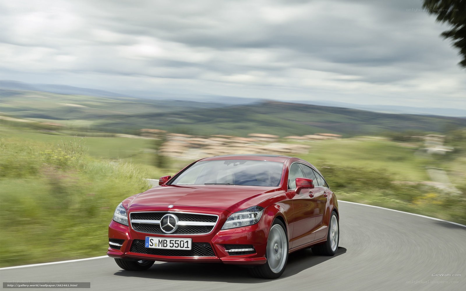Red Mercedes-Benz CLS driving on a road