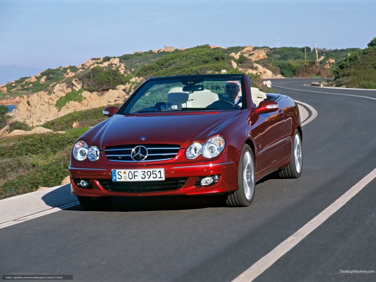 Red Mercedes-Benz convertible on coastal road