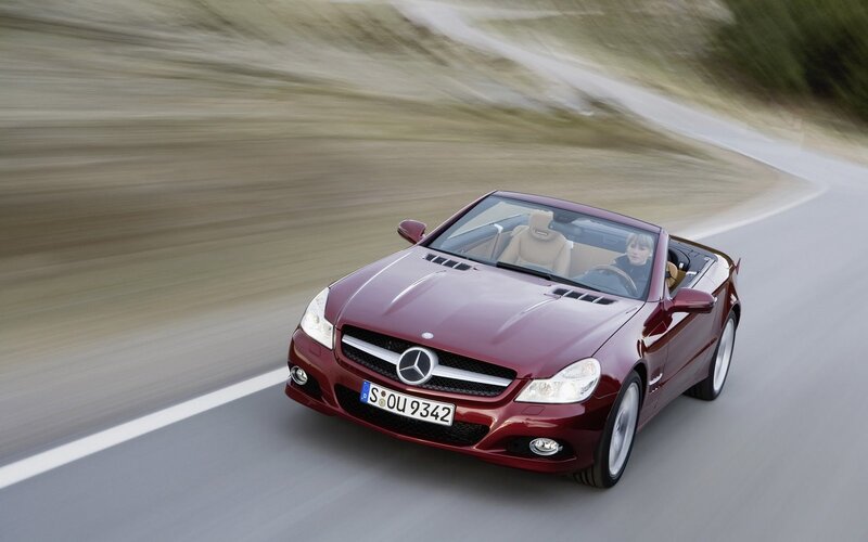 Red Mercedes-Benz convertible on road