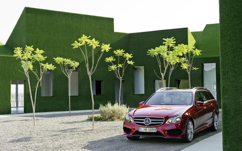 Red Mercedes-Benz in green setting