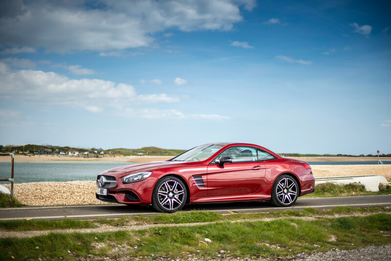 Red Mercedes-Benz SL500 by the coast