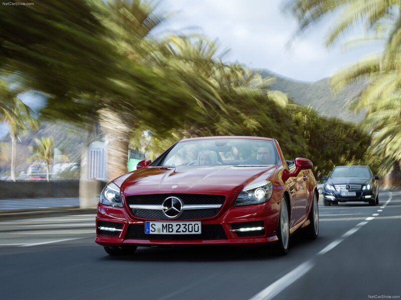 Red Mercedes-Benz SLK driving on a coastal road