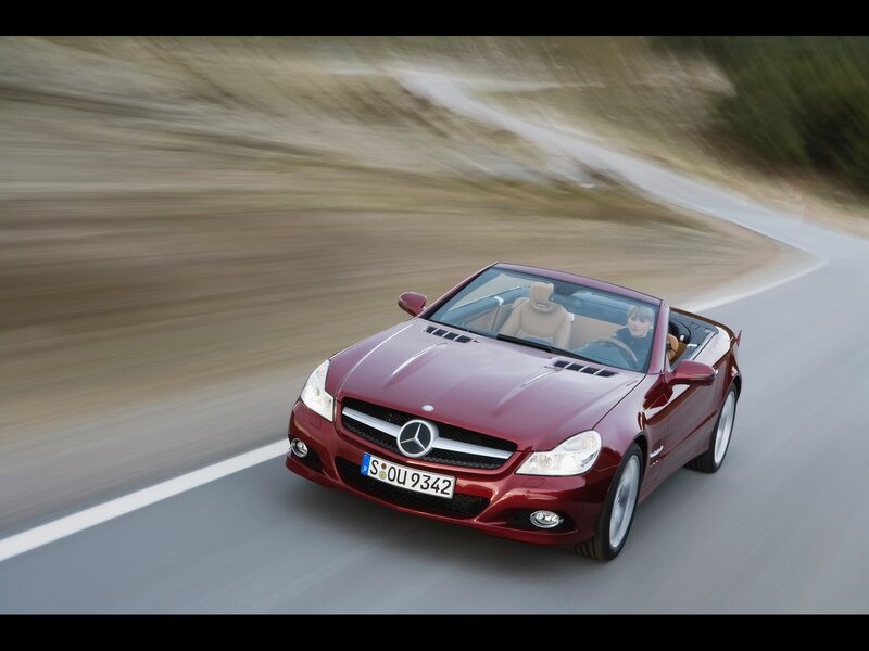 Red Mercedes-Benz SLK driving on road