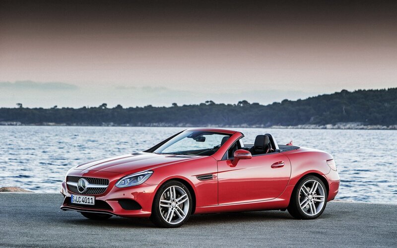 Red Mercedes-Benz SLK parked by water
