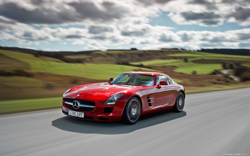 Red Mercedes-Benz SLS AMG on a country road