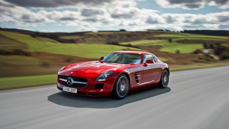 Red Mercedes-Benz SLS AMG on a country road