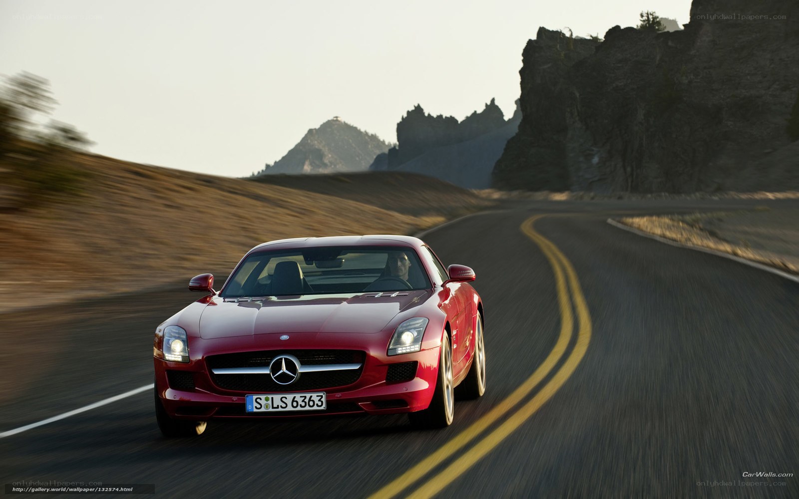 Red Mercedes-Benz SLS AMG on a winding road