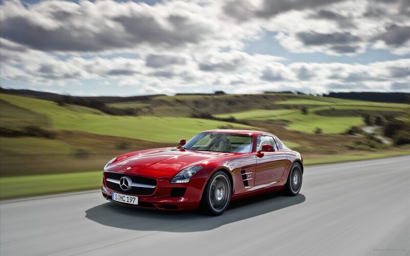 Red Mercedes-Benz SLS AMG on country road