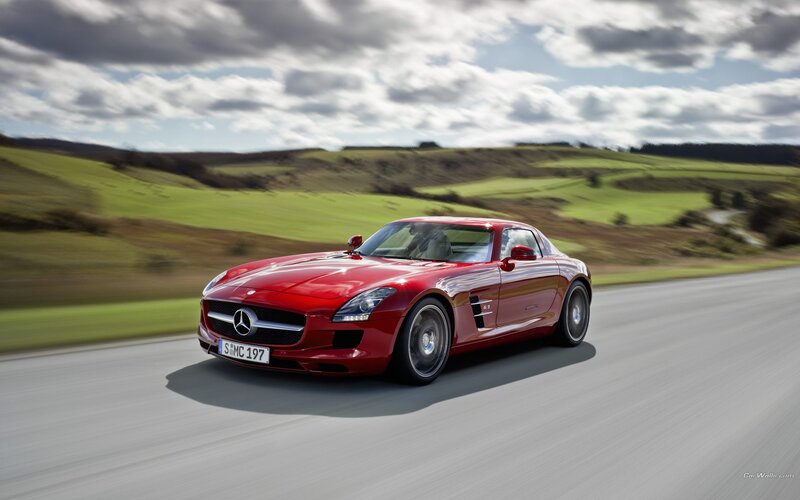 Red Mercedes-Benz SLS AMG on country road