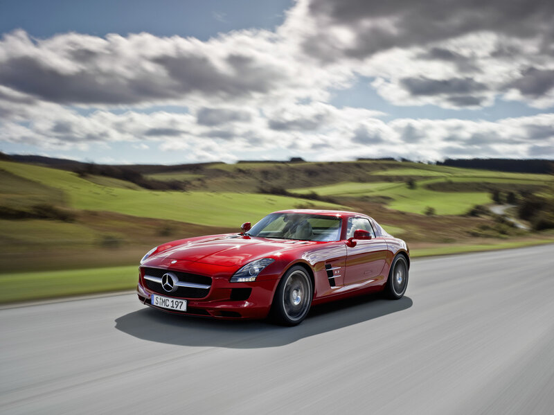Red Mercedes-Benz SLS AMG on country road