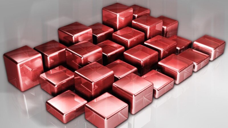 Red metallic cubes on reflective surface