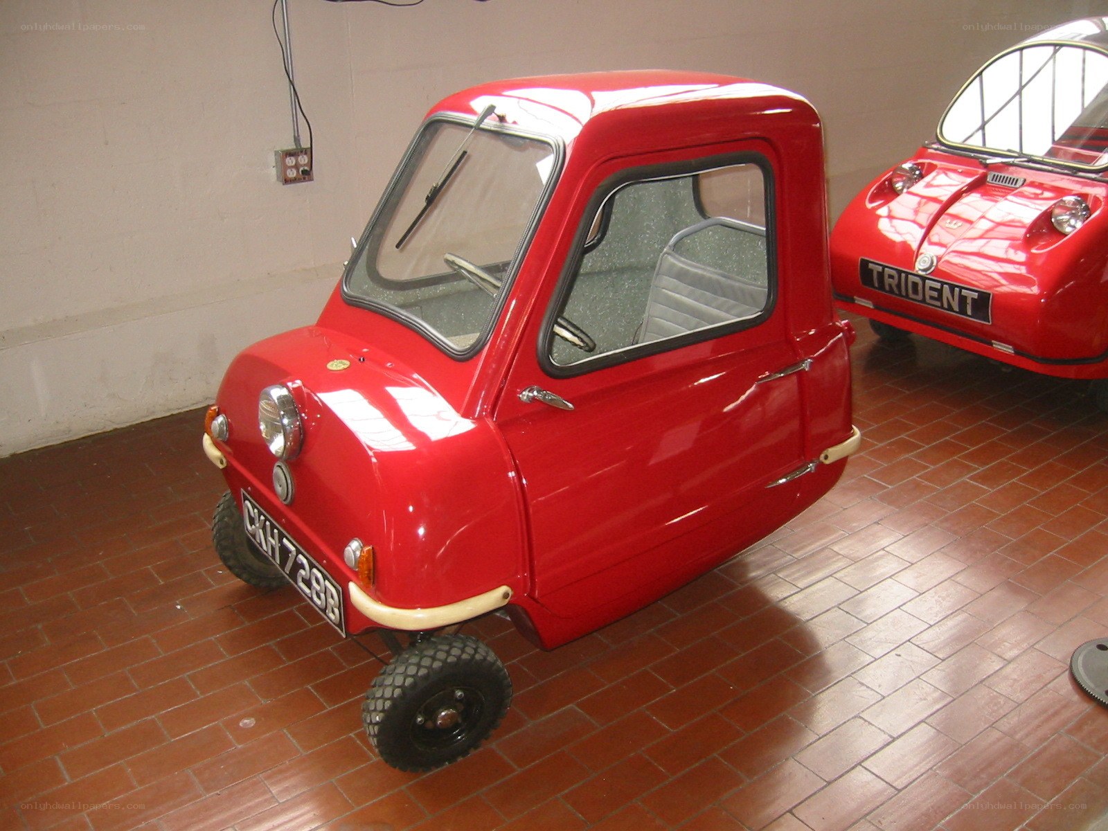 Red microcar in a garage