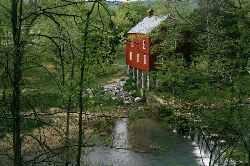 Red mill by a forest stream