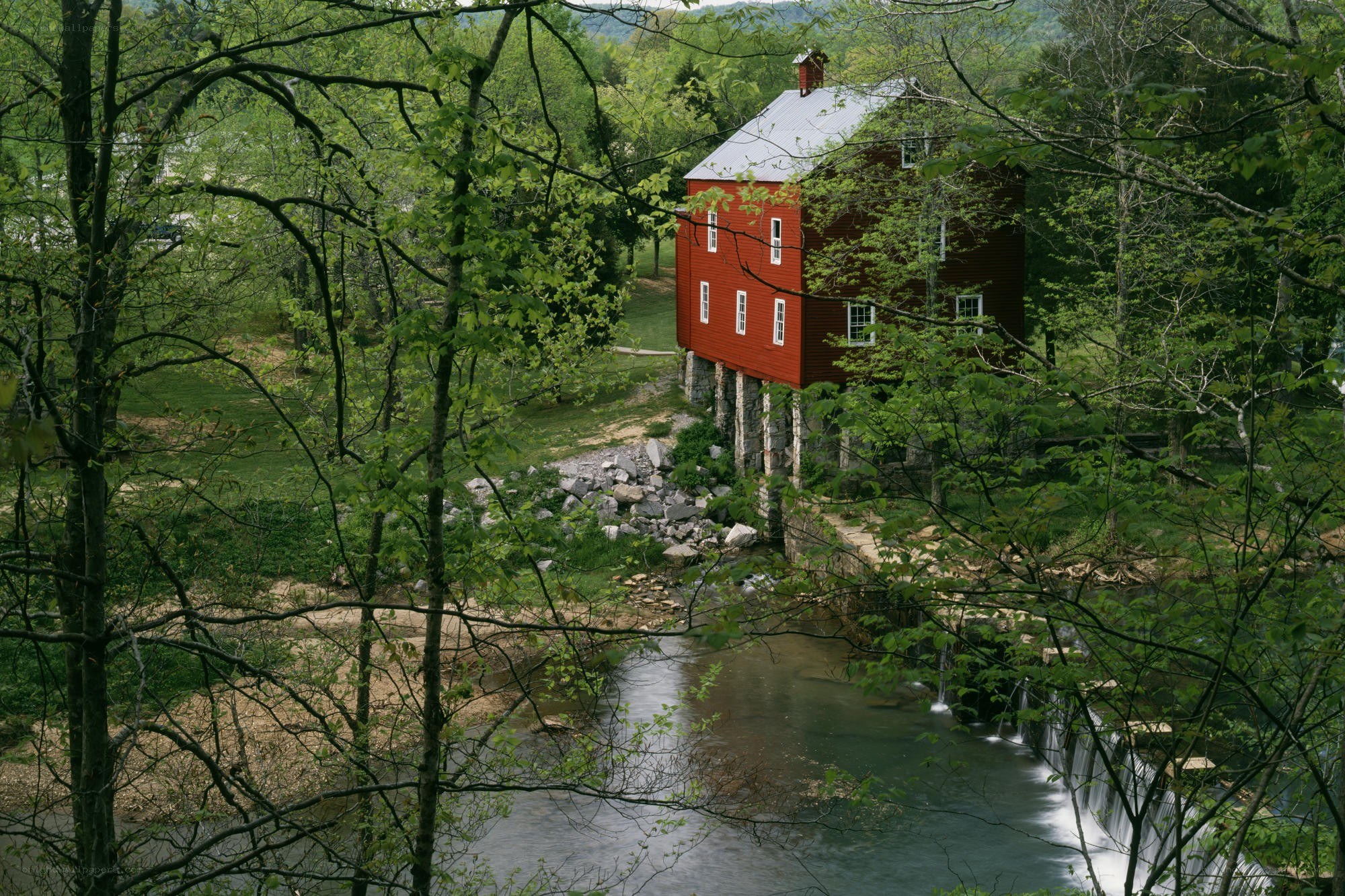 Red mill by a forest stream