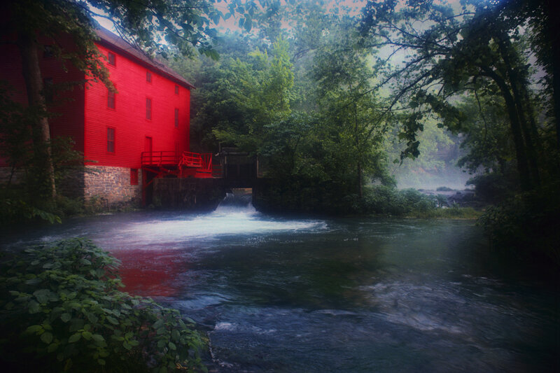 Red mill by a river