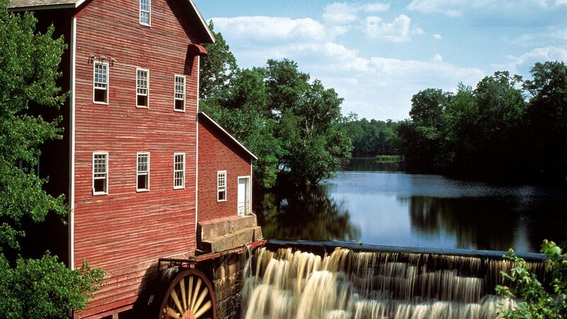 Red mill by a river