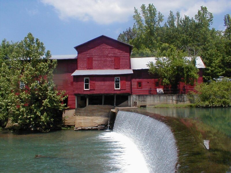 Red mill by a river
