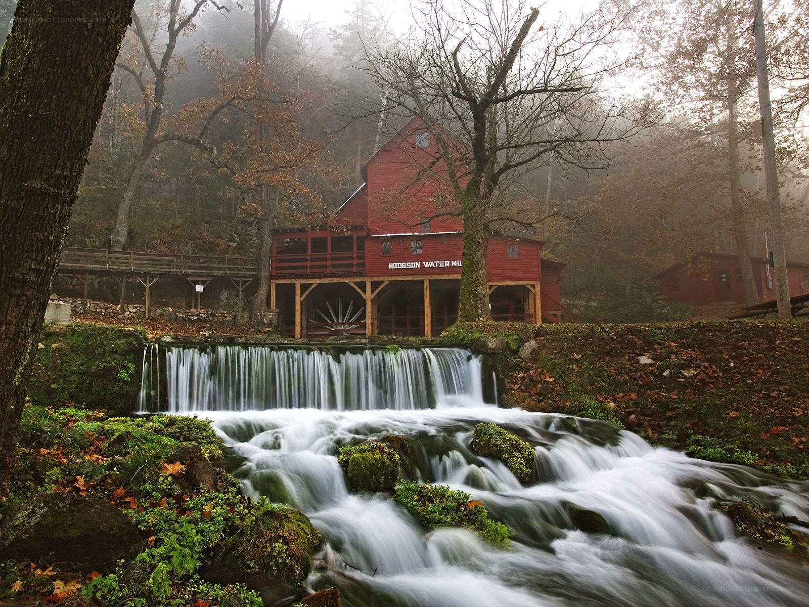 Red mill by a waterfall