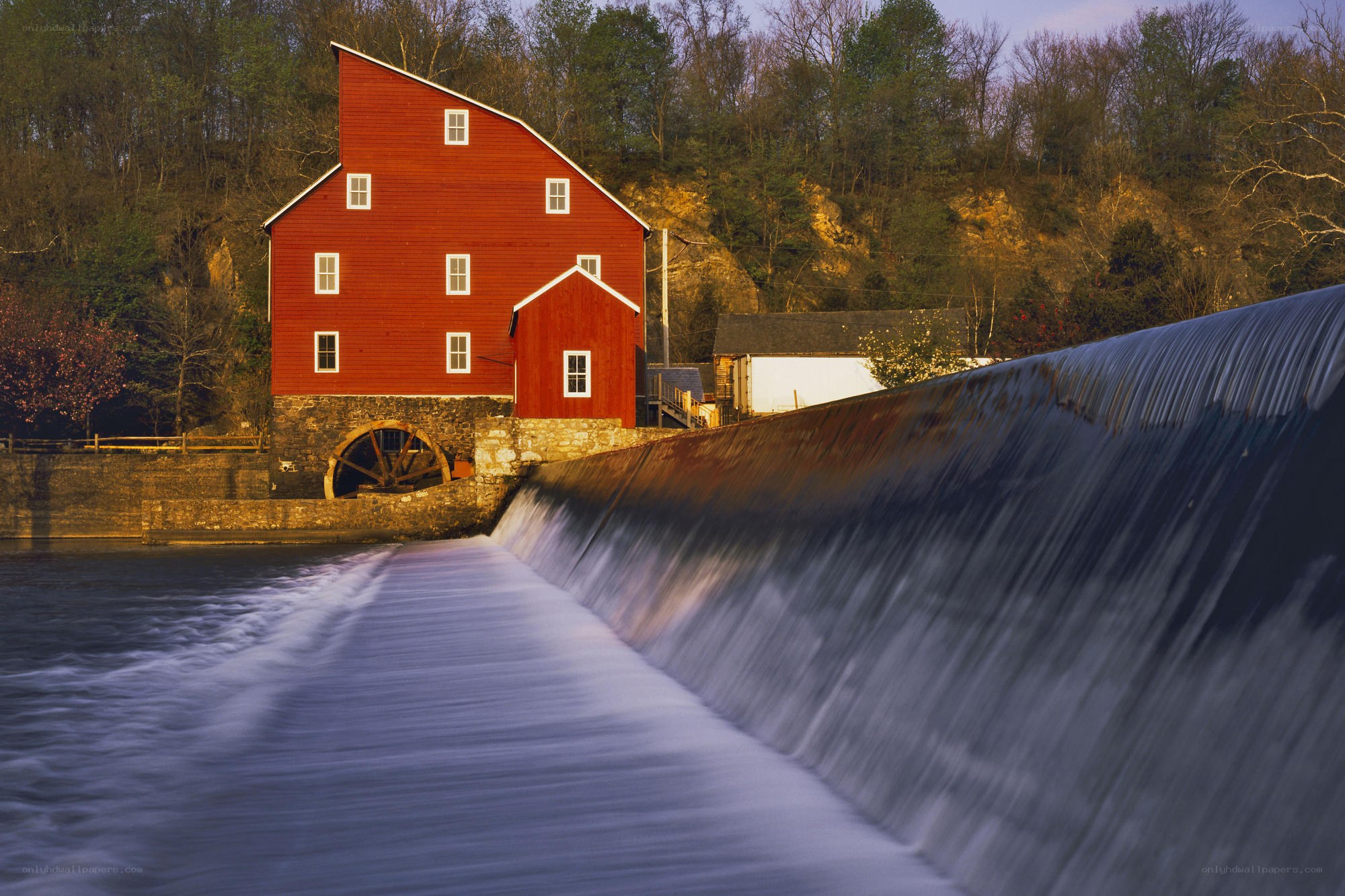 Red mill by a waterfall