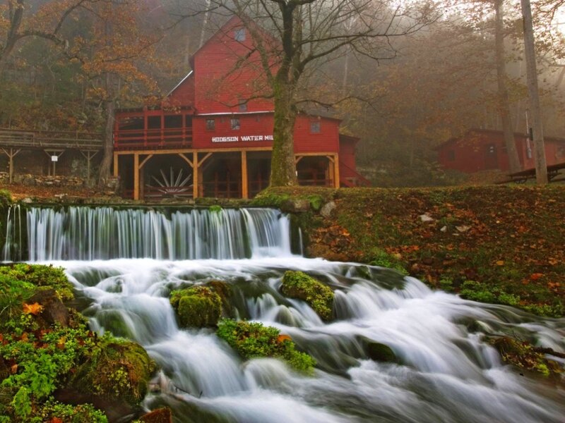 Red mill by a waterfall